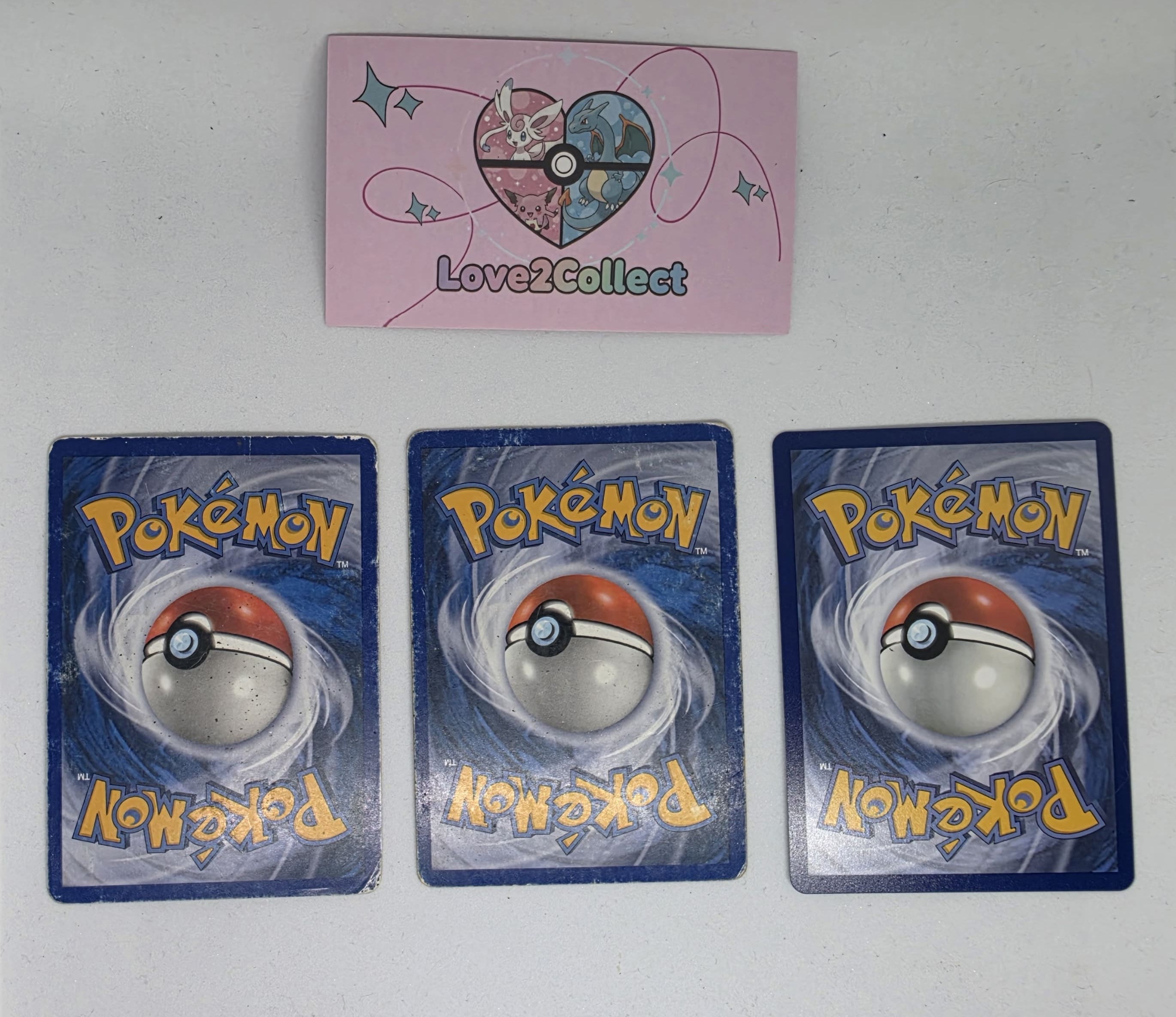 Trois cartes Pokémon montrant trois états de conservation différents